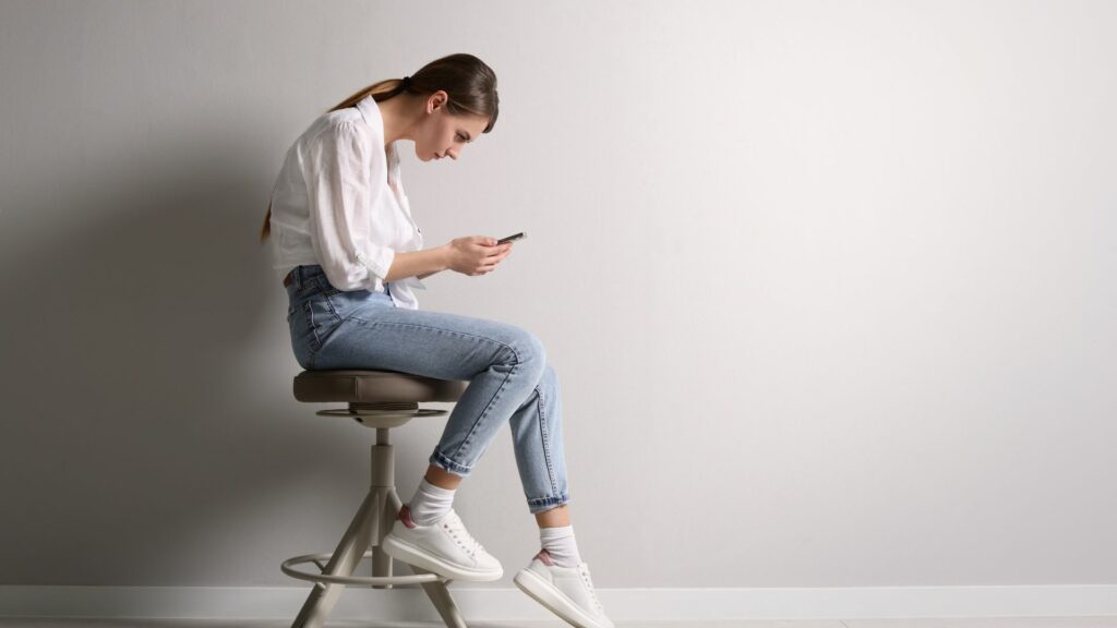 woman with her smartphone and having very poor posture