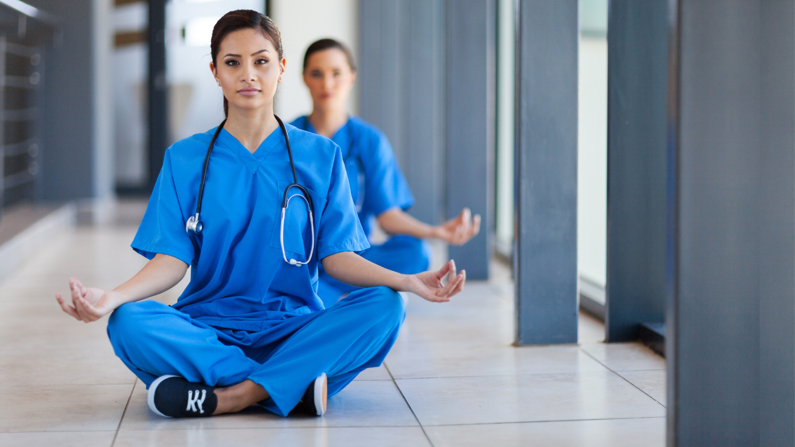 Two young healthcare workers meditation during break to release work pressure