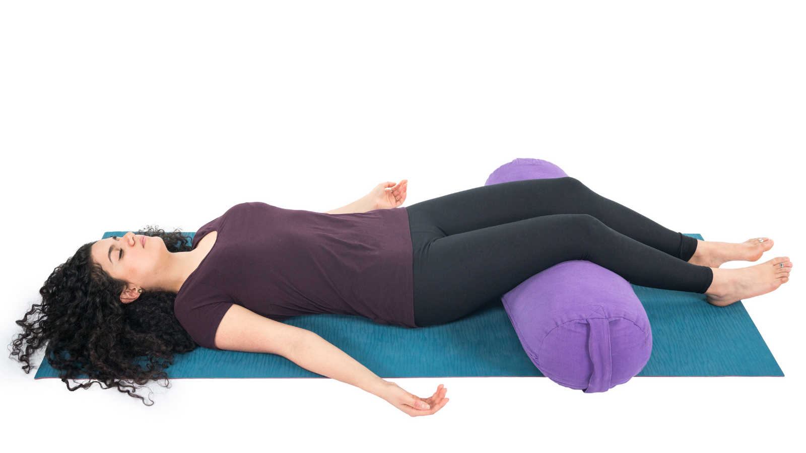 Corpse Pose or Savasana practiced with Bolster supporting the knees