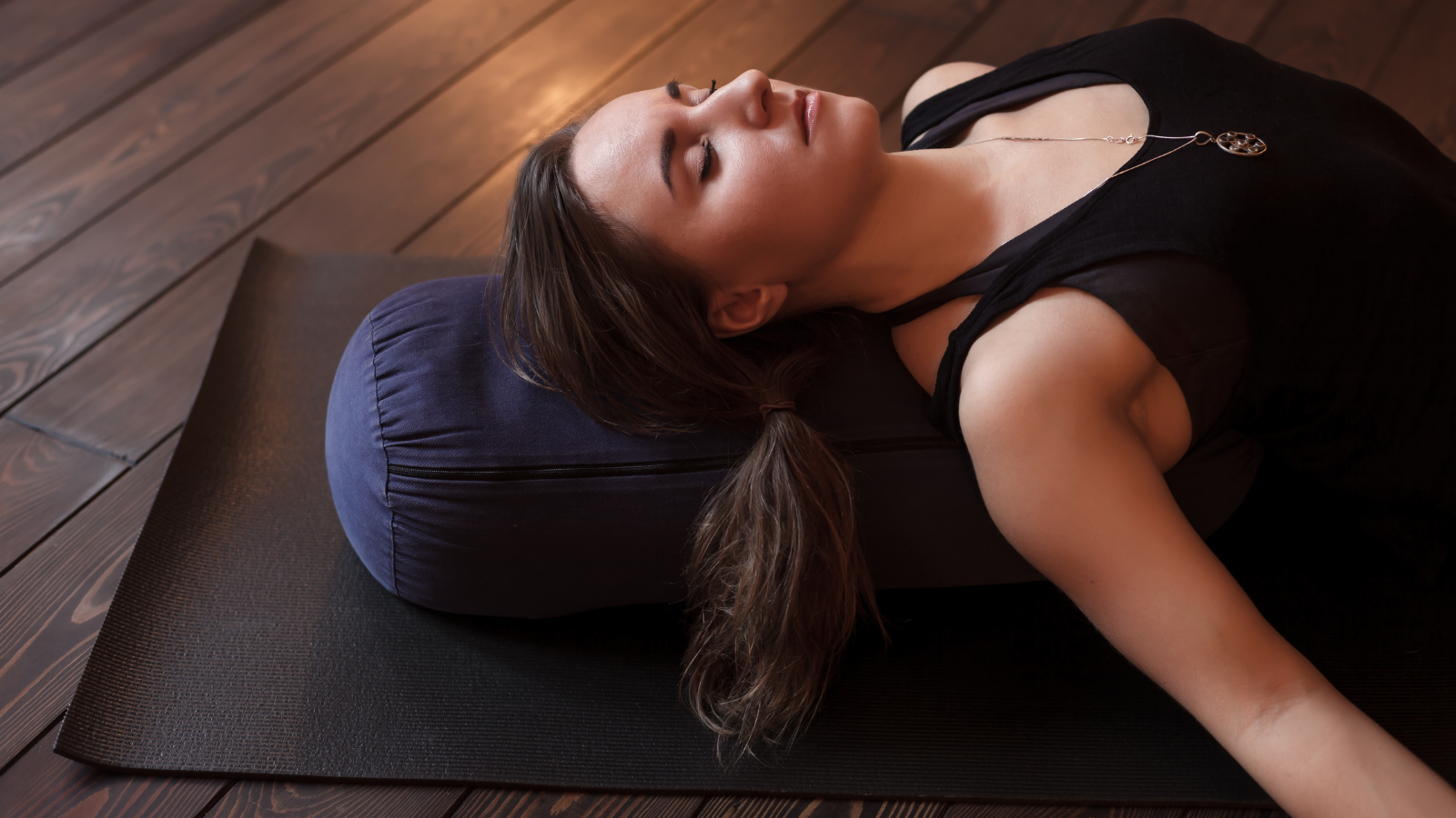 Woman resting after a yoga class in savasana and breathing practices