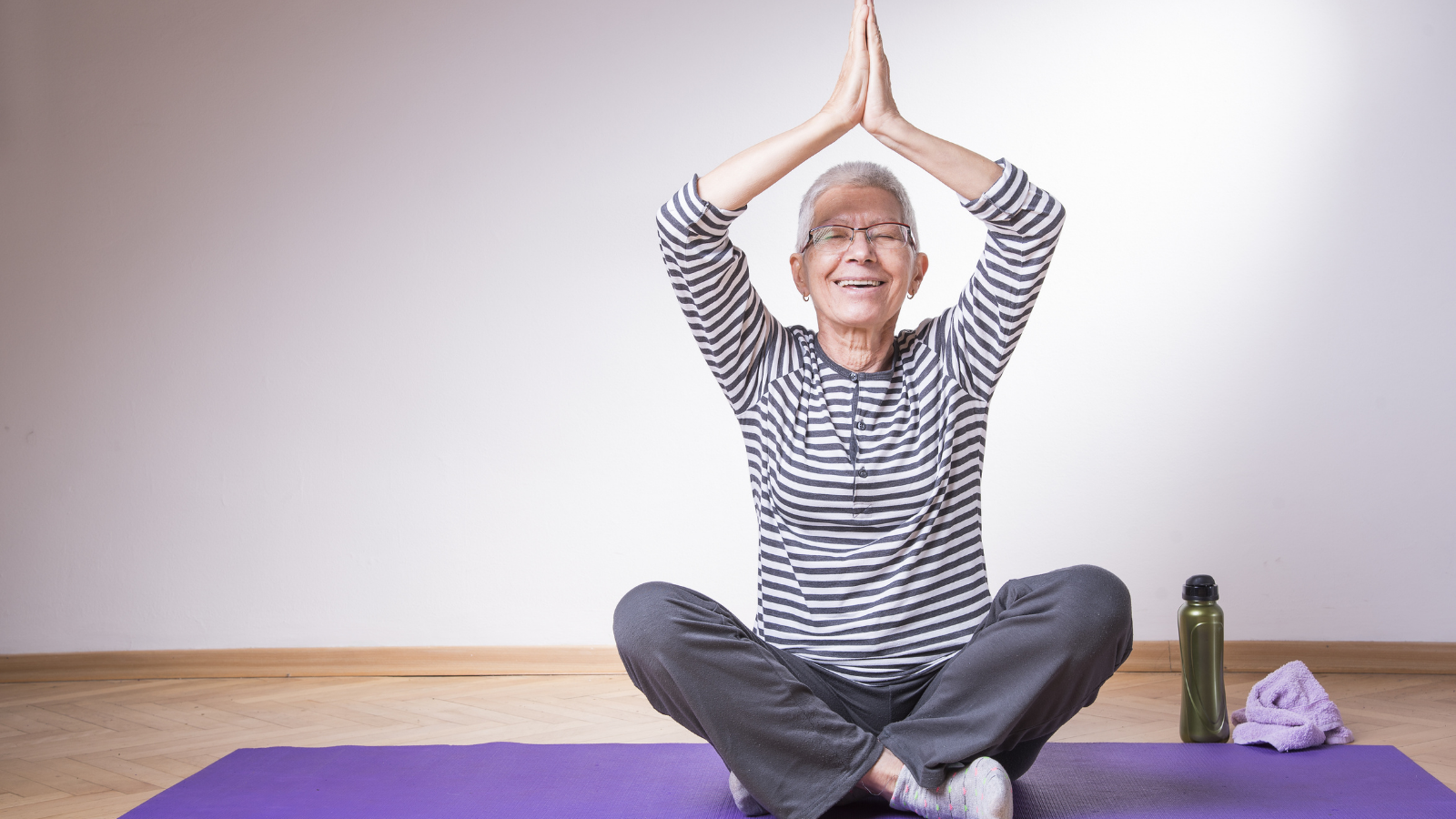 Healthy senior woman restart yoga practice, keeping herself relaxed and healthy and comfortable