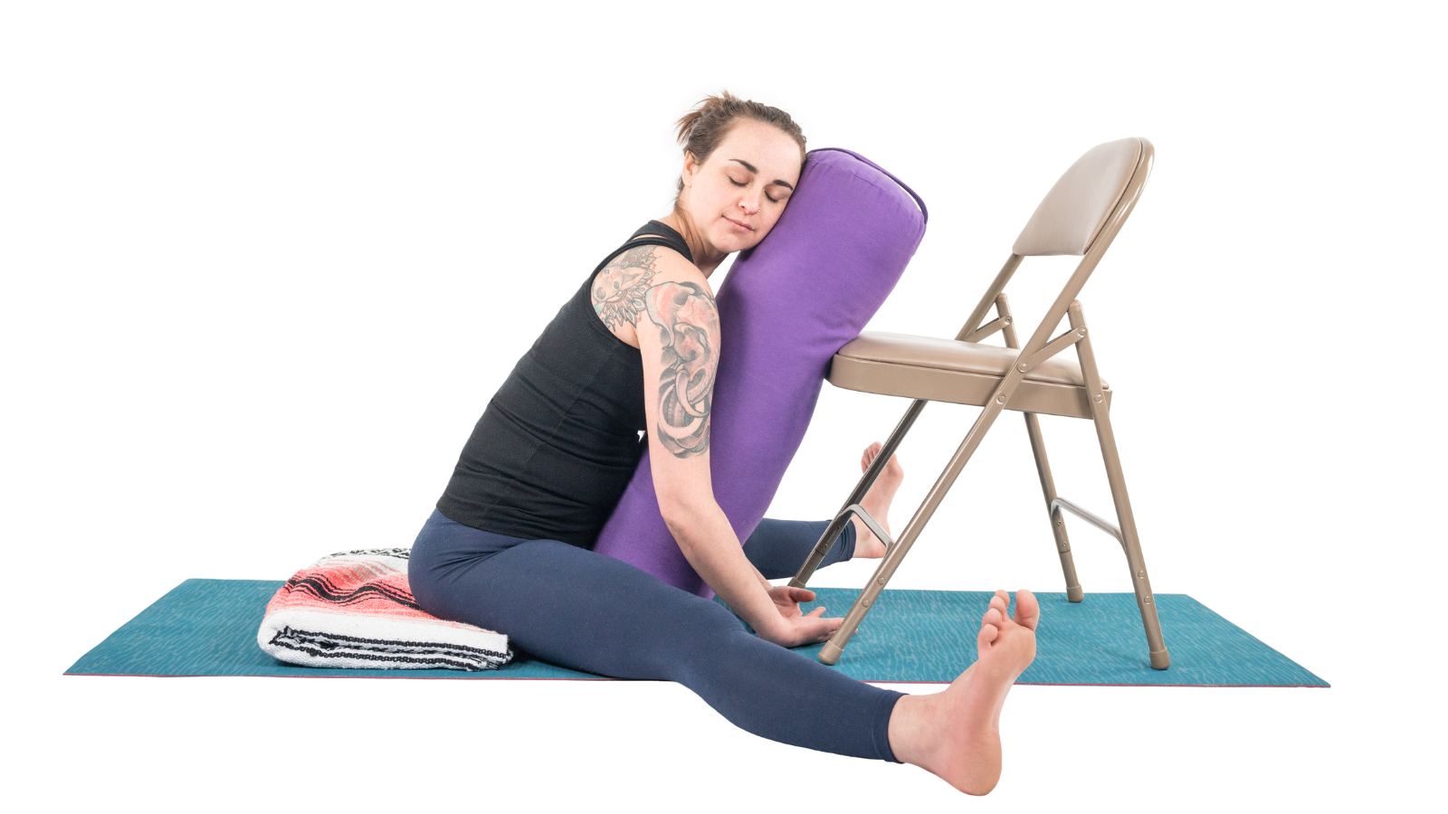  A restorative version of Upavista Konasana practiced with the help of a chair and support of a bolster 