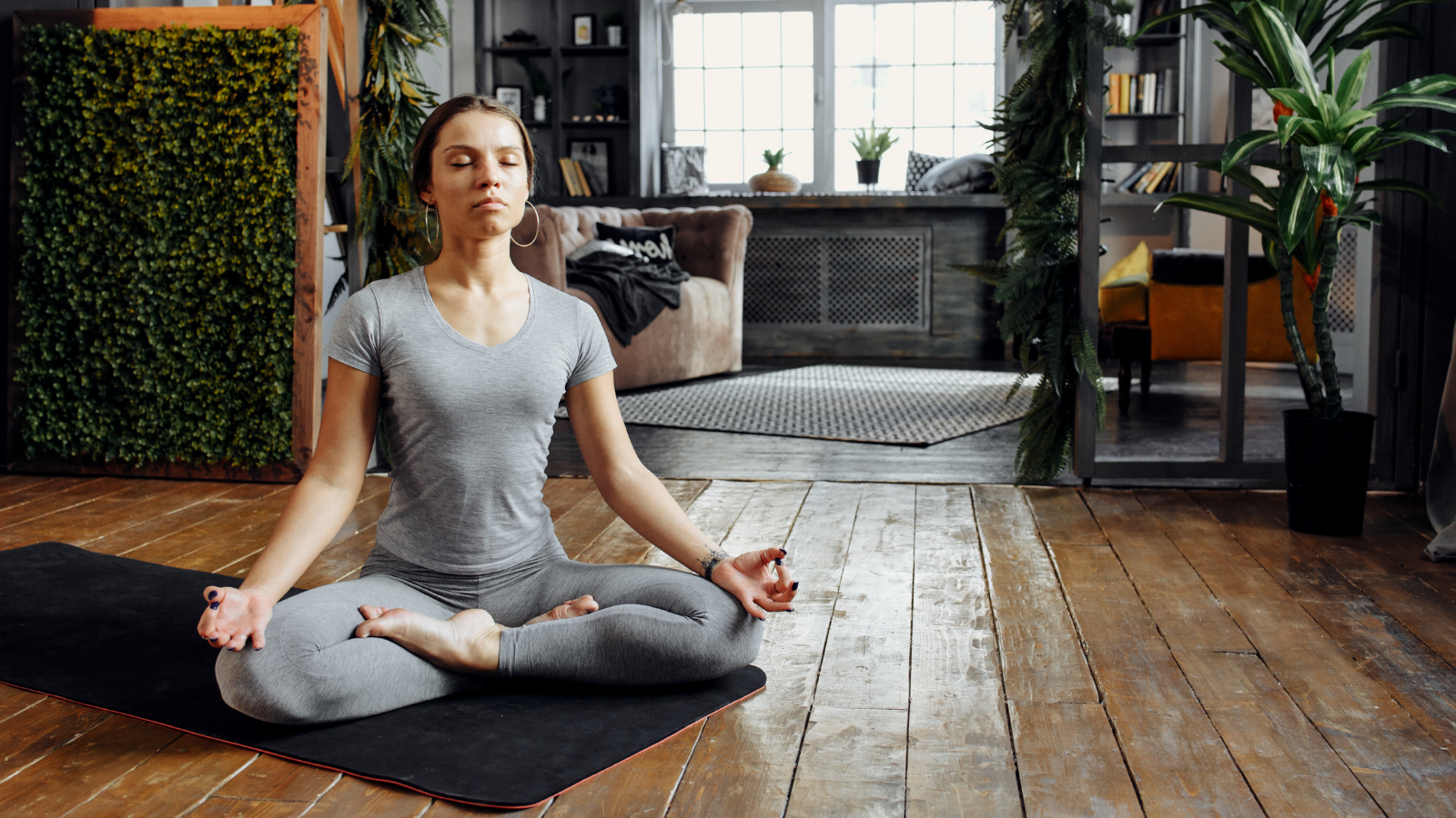 Woman practicing home yoga and meditation to sleep better with no to minimal nighttime light