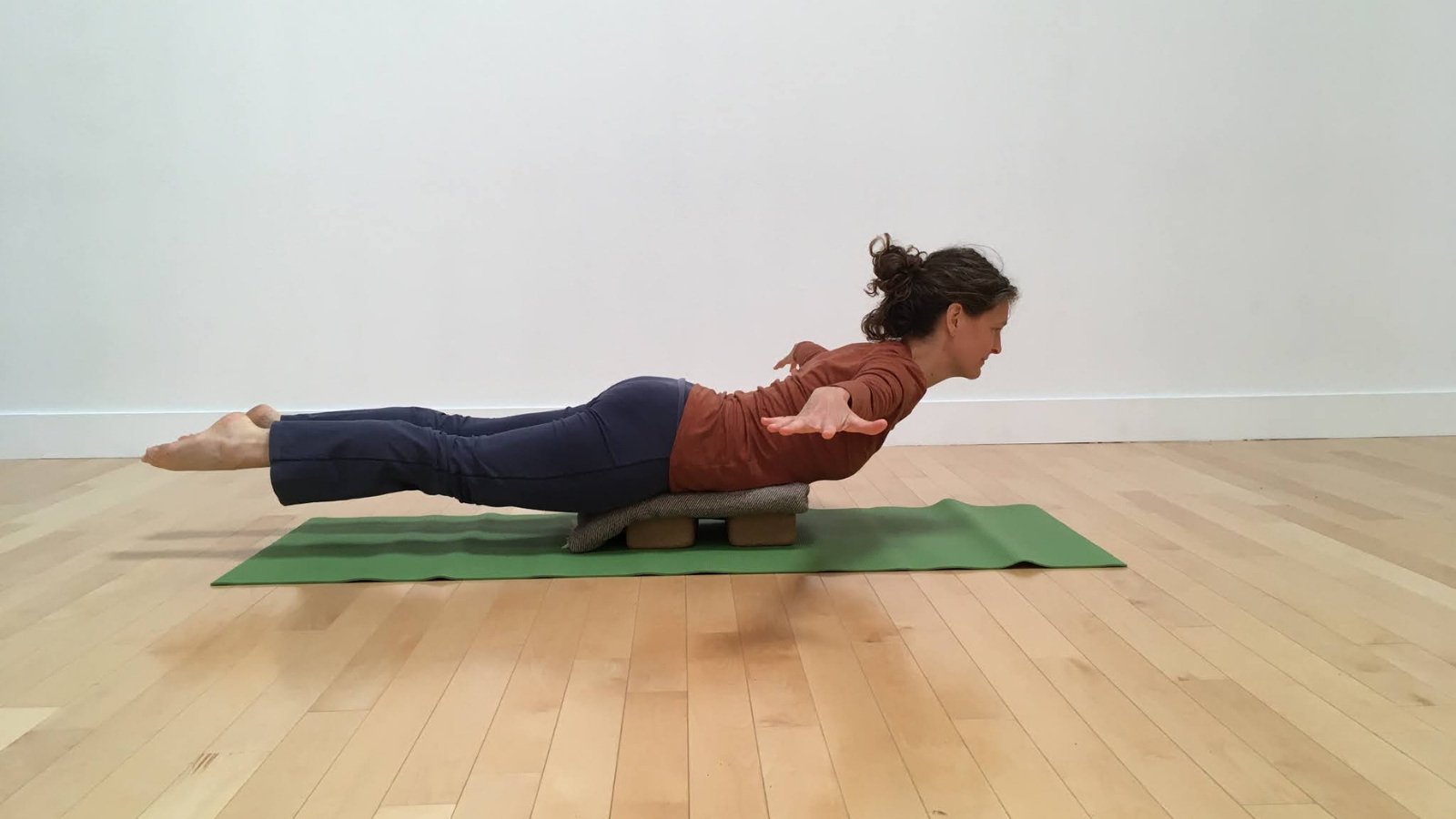 how to practice Arms-to-the-side variation of Locust pose or Salabhasana with props