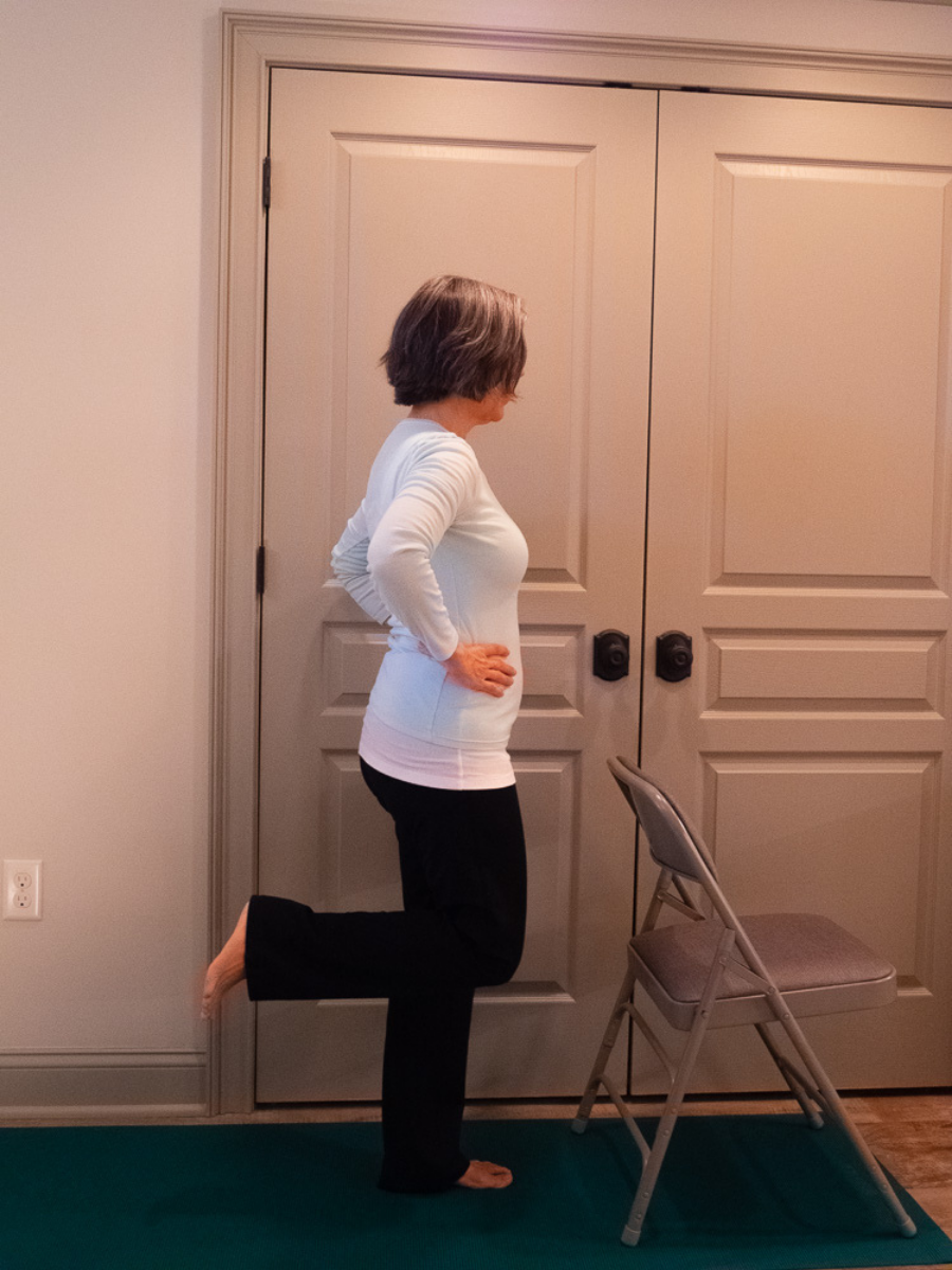 Dancer's Pose or Natarajasana, a beginner-friendly balance pose, is shown in a basic variation.